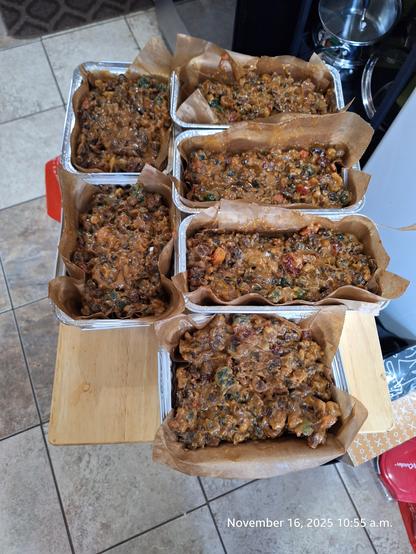 Six fruit cakes ready for baking.