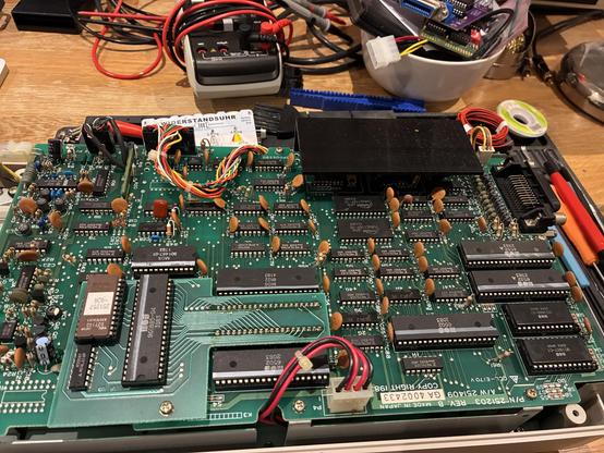 An opened computer peripheral with lots of chips, dated 1983. Two 6502 are visible, two 6532, a 6522 and many more supporting logic chips.