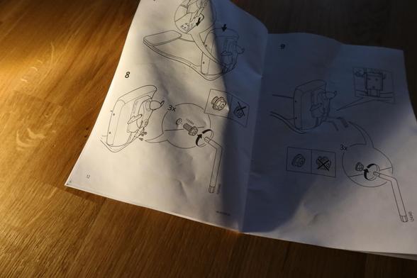 Page from the assembling instruction of an IKEA "Markus" chair, with page showing how to attach the seat.