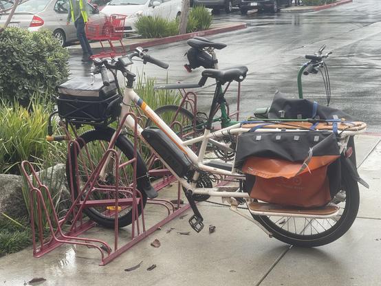 Three bicycles parked on a rack in the "Uptown Monterey" shopping center on a rainy Nov 15 afternoon.