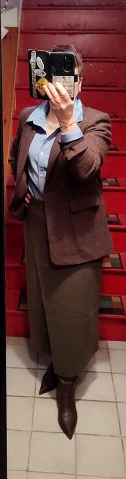 Pale blue satin blouse, olive green wool column skirt. Brown check wool blazer. Brown boots, minimal gold jewelry.