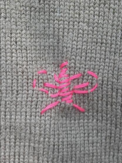 A small hole is quickly fixed with simple stitches. I added 2 antennae and some simple wing structures ... a pink moth repaired a dark sweater.