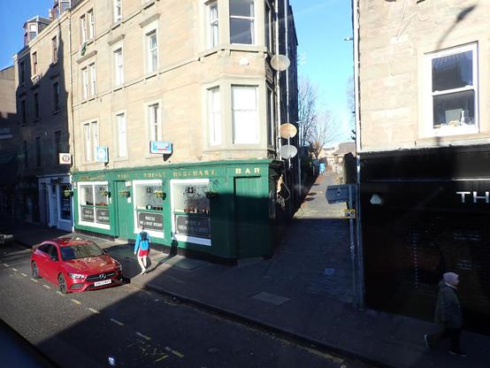 The Speedwell Bar, better known as Mennies, occupying the ground floor of a corner tenement block.