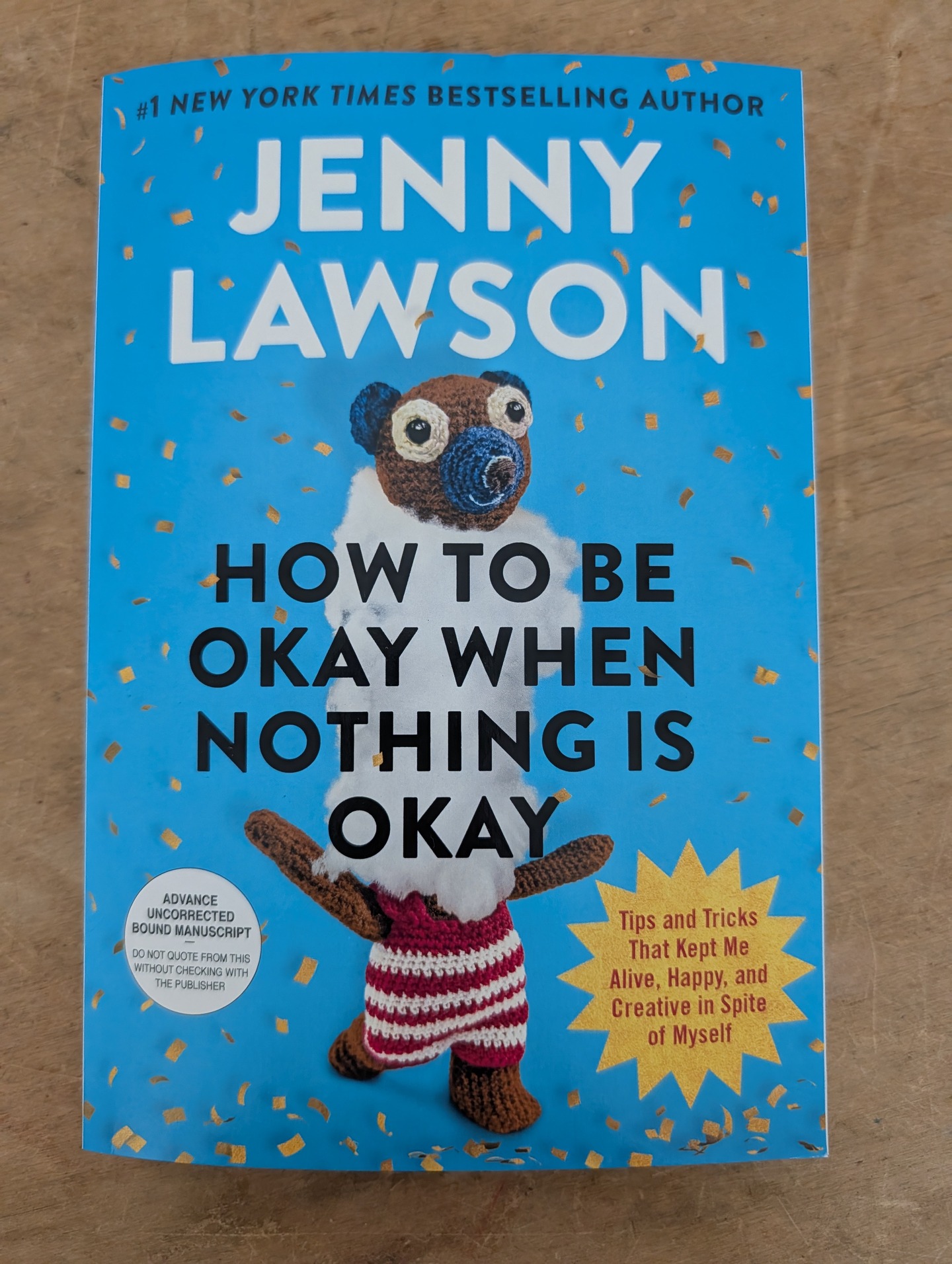 The Cover to Jenny Lawson's How To Be Okay When Nothing Is Okay, which features a cute stuffed animal with its head endearingly coming off.