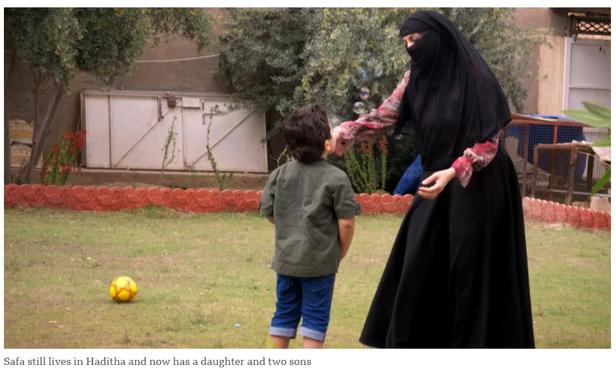 Safa in a garden with one of her sons.