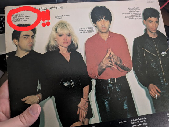 The back cover of the Blondie record, Plastic Letters. The band is pictured along with their roles in the band ("vocals", "guitar", etc.). Chris Stein's role has been circled in red with two explanation points because, in addition to being "lead guitar" and "bass", the album lists him responsible for "vibes". The album came out in 1978.