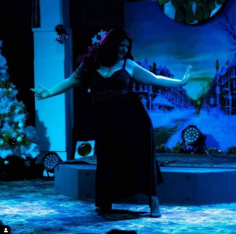 An in motion shot of me twirling on stage doing a Christmas variety show. When I'm on stage the world melts away and I am most myself.