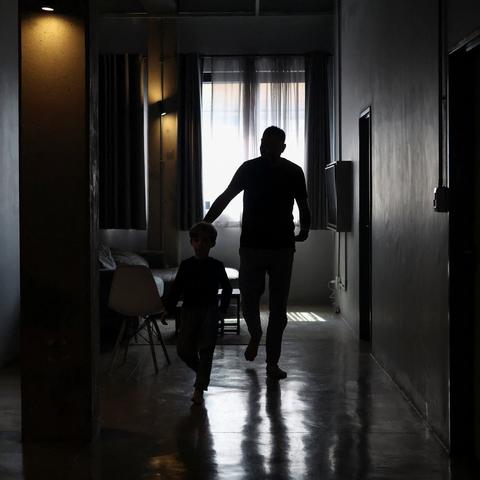 A Palestinian man, one of those granted entry to South Africa, with his child at an undisclosed location in Johannesburg, on Friday.