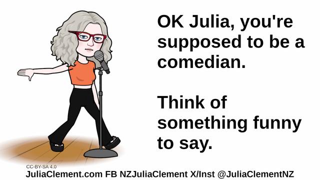 Julia at a mic in a stand, her arm looks almost like she's doing a mic drop. Text: OK Julia, you're supposed to be a comedian. Think of something funny to say.