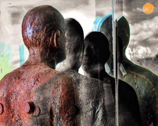 statue en métal corrodé placée devant un jeu de miroirs