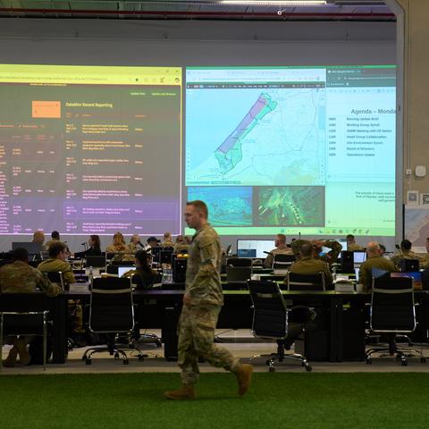 U.S. military personnel and other officials monitor screens displaying imagery of the Gaza Strip during a media tour of the new Civil-Military Coordination Center in Kiryat Gat, Israel, on Monday.
