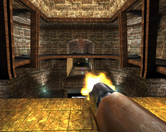 A screenshot from OpenArena featuring the player firing a rusty rocket launcher down a stone block hallway below themselves in the teleporter area of the Quake deathmatch classic map "The Dark Zone"