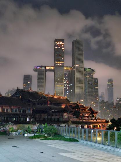 a cluster of skyscrapers with another one sort of running through the middle sideways, behind a traditional building, with some cool cloudy fog stuff that makes it look even more cyberpunk and amazing?!