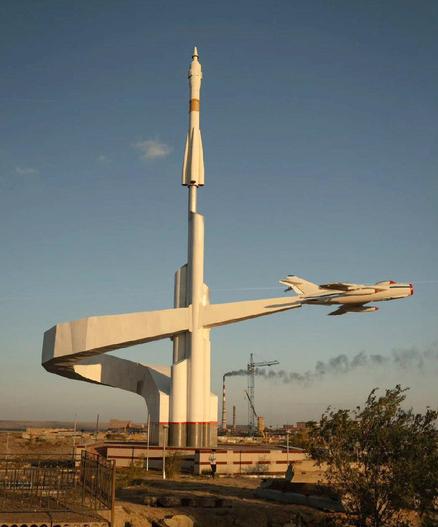 Photo of a large concrete monument which depicts a rocket and a jetplane.