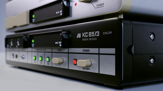 A photorealistic close up rendering of the KC 85/3 computer with keyboard, floppy controller and floppy drive on a white background with shallow depth of field.