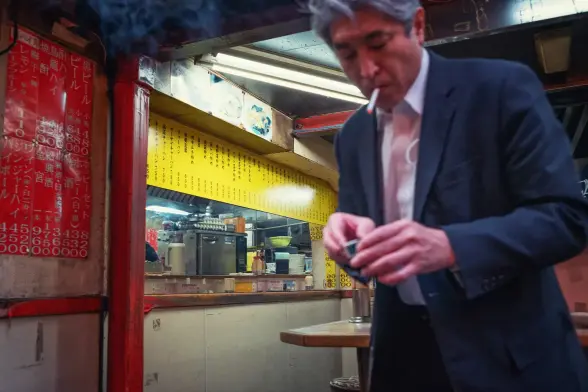 Man lightning a smoke on the street