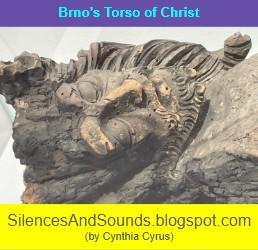 A scorched sculpture of Christ with carved wooden moustache, beard, and hair; blog post title: Brno's Torso of Christ