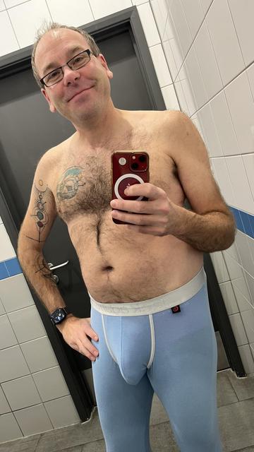 Hairy gay guy wearing sky blue Jack Adams long johns with white waistband
