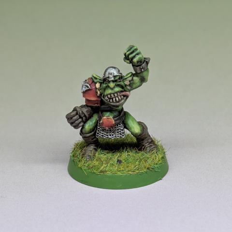 A blood Bowl goblin with raised fist