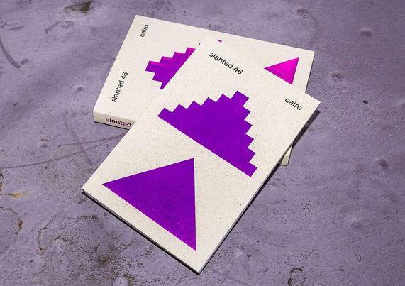 Two graphic design magazines titled "Slanted 46 Cairo" featuring bold purple geometric shapes on a textured surface.