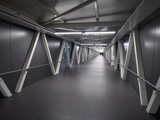 A long empty and grey corridor.