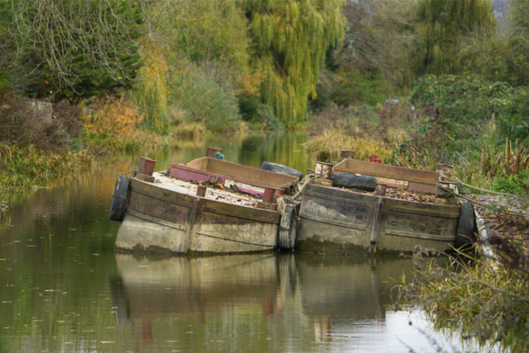 a pair of sinking narrow barges, listing at about the same angle although one of them has stayed that way while the other shows tide marks at various angles. A warm looking picture with weeping willow in the background, belying how cold it actually is!