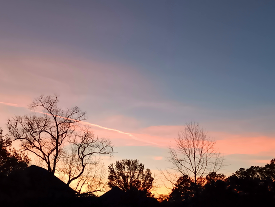 Yellow, orange & pink sunset with scattered thin clouds.