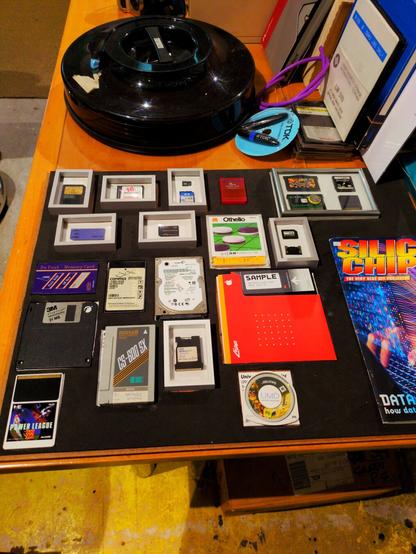 A wooden table covered with old disks.