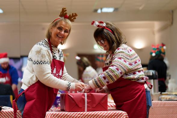 Davinia Pritchard and her sister Jo, National Lottery winners, wrapping toy gift boxes at ToyBox Project in Caerphilly.