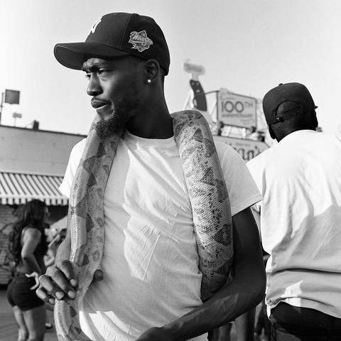 snake handler with python around neck on coney island boardwalk