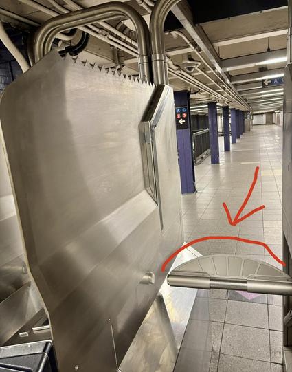 Pic of a NYC turnstile, arrow pointing to the new curved additions, making it harder to jump over the turnstile.