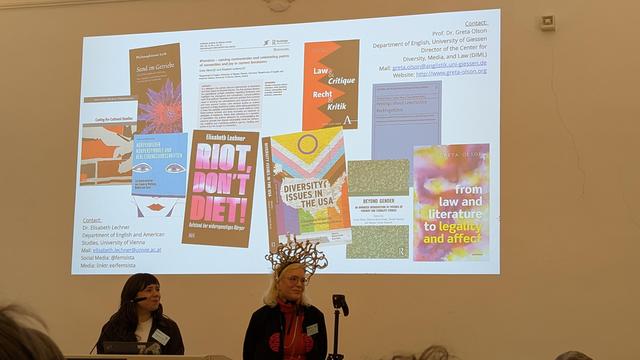 Elisabeth Lechner & Greta Olson in front of their PowerPoint slides, showcasing the books mentioned in their talk