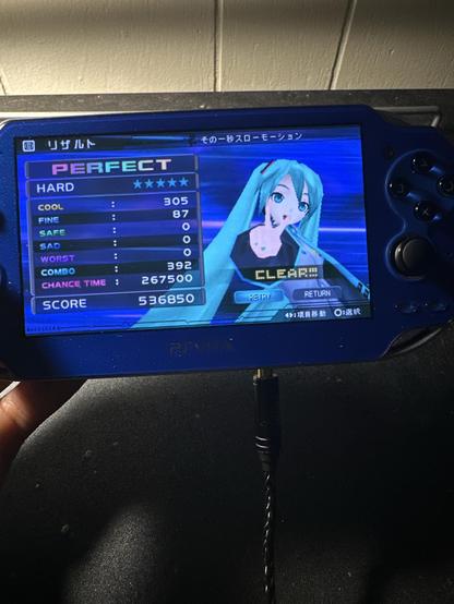 Blue PSVita displaying  Hatsune Miku Project Diva. The song title is その一秒スローモーション. Hard Mode ⭐️⭐️⭐️⭐️⭐️ PERFECT