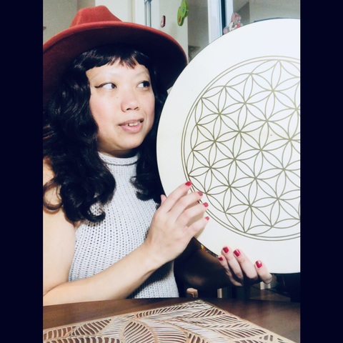 Crissy gazing in love with her flower of life drum