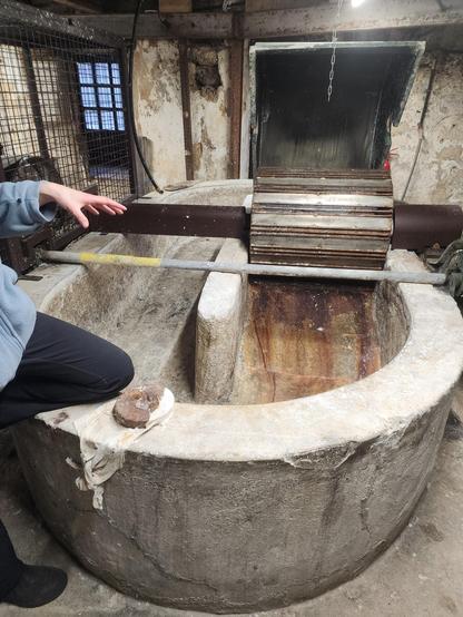 A very large stone trough, with a Hollander beater on one side for grinding fabric into paper fiber.