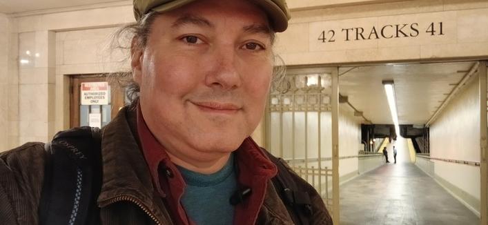 A slightly smiling selfie in front of a ramp in Grand Central Terminal, with "42 Tracks 41" printed above the entrance.