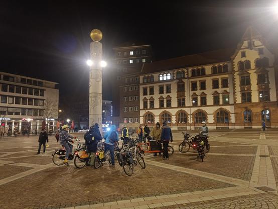 Cyclists round a monument