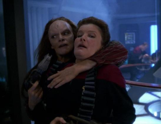 Seska holds Janeway hostage at the nossle of a phaser in Voyager's Engineering deck.