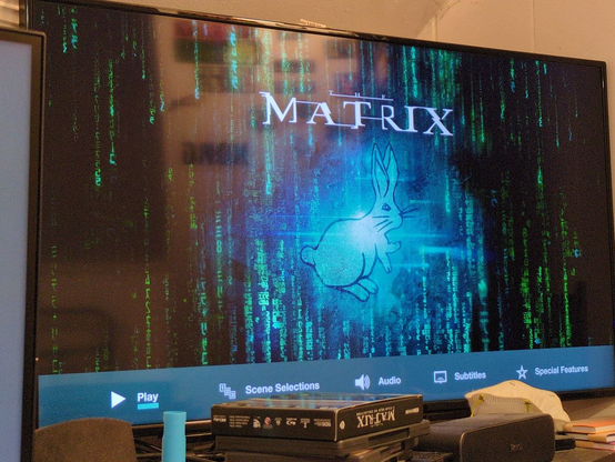 Blu-Ray loading screen for the Wachowski Sisters' film "The Matrix", showing the falling green glyphs and the "white rabbit" at the center