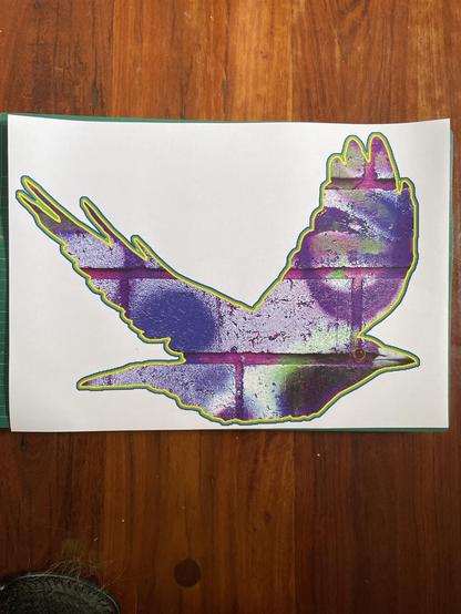 A print out of a flying purple magpie with the texture of a brick wall.