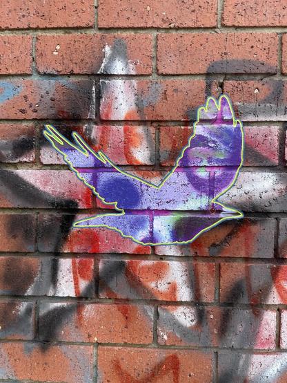 Ac lose up of a brick wall with graffiti. A paste-up of a flying purple magpie is in the centre.