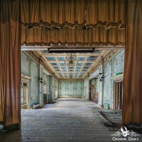 view from stage, through gold curtains