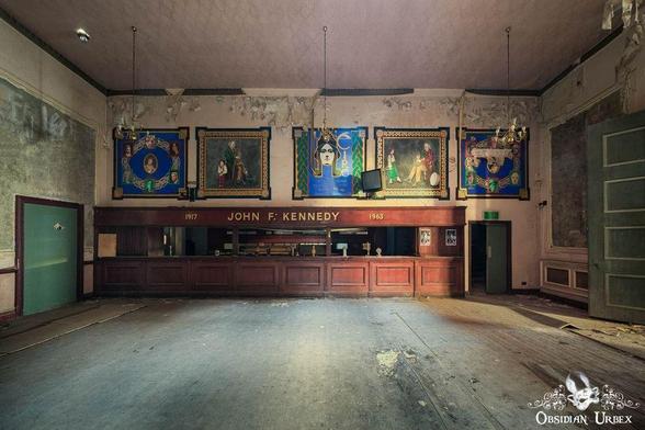 wooden bar with portraits and "John F kennedy" in gold letters on bar