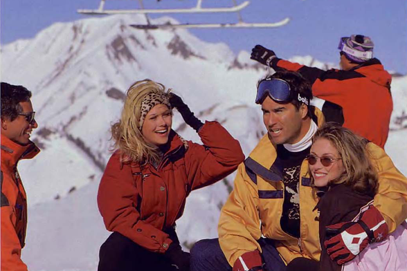1997 Group of Friends Preparing for Skiing Excursion

In this vivid image, a group of friends dressed in colorful winter sports gear is seen gathered on a snowy mountain slope.
They appear to be getting ready for a skiing adventure as evidenced by the ski equipment and protective goggles they are wearing.