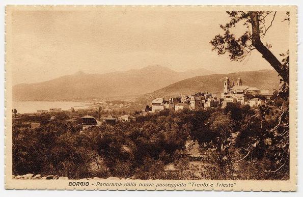 The image is a sepia-toned postcard depicting an old photograph of the Borgio village. The landscape shows dense vegetation in the foreground, leading up to clusters of buildings that make up the village. Prominent among these structures are churches with tall bell towers and domes, indicating their importance within the community.

In the background, rolling hills or low mountains rise against a flat horizon line, creating a picturesque backdrop for the settlement. The sky is overcast with no visible sunlight, which gives the entire scene a somewhat muted appearance typical of vintage photographs.

At the top left corner, text in Italian reads "BORGIO - Panorama dalla nuova passeggiata 'Trento e Trieste'", indicating that this panorama was taken from a new promenade called Trento and Trieste. The postcard is bordered with what appears to be perforations for easy handling or display.

Overall, the image conveys a sense of historical charm and captures a glimpse into life in Borgio during an earlier time period.