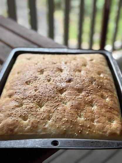 A 25mm deep baking dish full of nicely browned bread in a big slab.