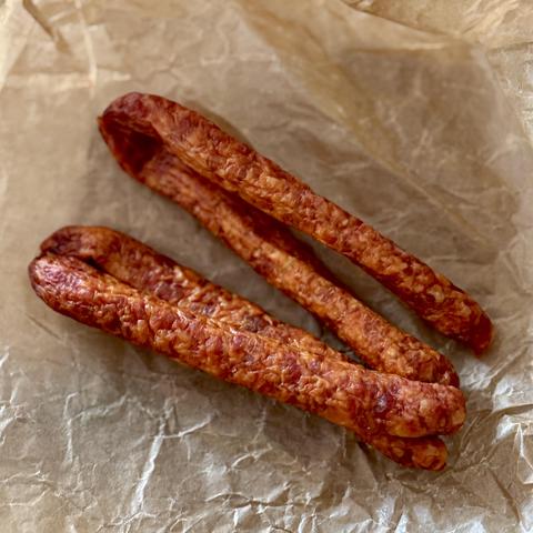 The yummy little sausages, looking very orange from the paprika powder in them.