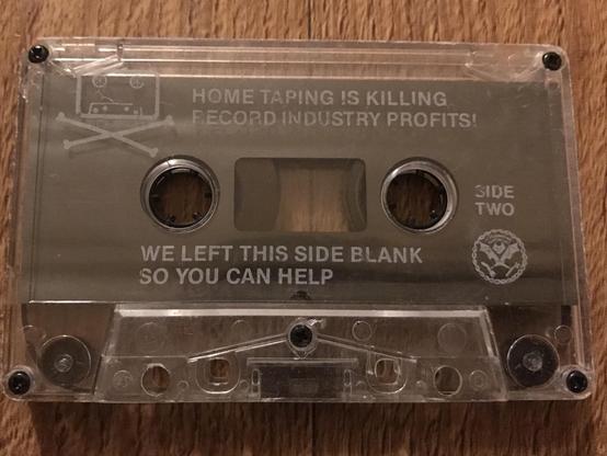 Dead Kennedys cassette tape.  It bears the slogan 'home taping is killing record industry profits '.
Then below ' we left this side blank so you can help '