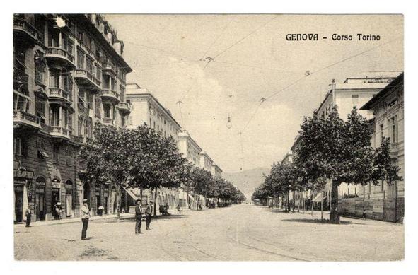 The photo depicts a wide, tree-lined street in an urban setting. On the left side of the road, there are multi-story buildings with visible balconies and windows; some structures appear to be residential while others could serve commercial purposes given their architecture. The right side mirrors this layout but is less dense with fewer trees. Two individuals can be seen walking on the sidewalk in a relaxed manner. In the distance stands a prominent building that resembles an institutional or governmental edifice, possibly due to its grandeur and classical design features like columns.

The street itself appears clean and well-maintained, lacking any visible traffic which suggests either low-traffic hours or perhaps pedestrian-only zones. Overhead power lines crisscross above, indicating the presence of public transportation such as trams in this area. The sky is overcast with a light haze that obscures distant details.

The image bears text at the top: "GENOVA - Corso Torino," suggesting it's taken on Corso Torino street in Genoa, Italy. This could imply historical context or serve to identify specific location for viewers familiar with Italian cities. The sepia tone and vintage feel of the photograph suggest that this may be an old postcard capturing a moment from history.

The bottom right corner contains additional text: "Ferro Candilera," which might refer to the photographer, publisher, or another party associated  [...]
