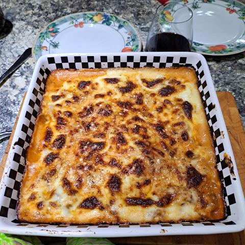 A square dish with lasagne in it; the cheese sauce on top is pleasingly browned.